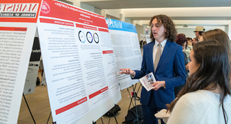Image of student presenting academic research.