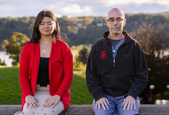 Allan Tibbetts and student participant from Train Your Brain Course practicing mindful breathing outside the Marist Rotunda. Photo by Nelson Echeverria/Marist College.