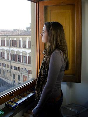 Photo of student looking out a window at Florence