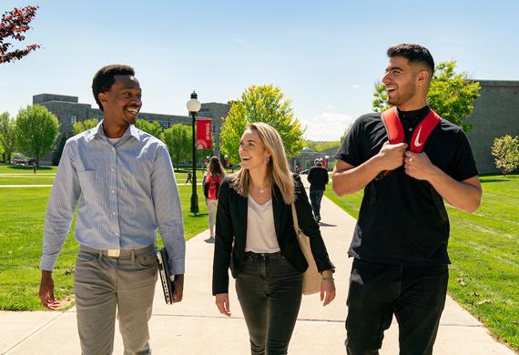 An image of three students walking to class. 